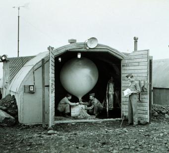 Army Air Force meteorologists prepare to launch a hydrogen-filled balloon that will carry a radiosonde up in the air to measure temperature, humidity, and atmospheric pressure and transmit the data back to a ground station. Courtesy of the NOAA Photo Library.