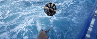 Drifting buoy being cast into ocean