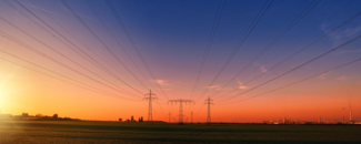Photo of sunset on horizon with electrical lines in background