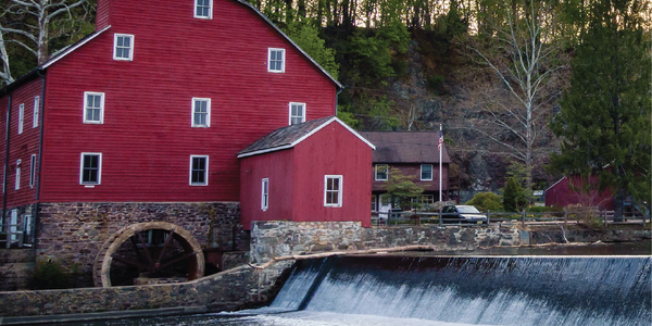 Red barn with mill house near a dam