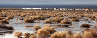 Flooding in the Mojave Desert with a train passing by in the background.