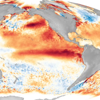 A bright red/orange band of unusually warm sea surface temperatures extends along the equatorial Pacific Ocean overlaid on a global map during 2016, one of the strongest El Niño events on record.
