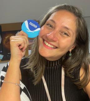 Photo of NCEI’s  Alessandra (Ale) Pacini posing with a NOAA patch. 