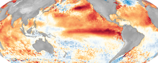 A bright red/orange band of unusually warm sea surface temperatures extends along the equatorial Pacific Ocean overlaid on a global map during 2016, one of the strongest El Niño events on record.
