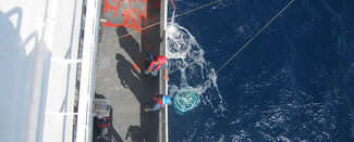 Photo of CTD instrument deployment in ocean