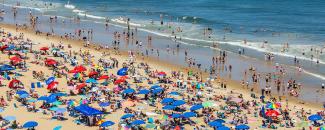 Photo of a crowded beach covered with umbrellas in Ocean City, Maryland, courtesy of iStock
