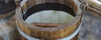 Photo of a wooden bucket filled with water