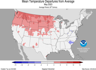 Map of the U.S. showing temperature departure from average for May 2023 with warmer areas in gradients of red and cooler areas in gradients of blue.